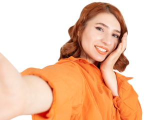 Taking selfie, close up portrait of young woman taking selfie. Caucasian girl taking pictures by her mobile phone smartphone Smiling, happy, fun, positive red bob hair lady touching her face gently.