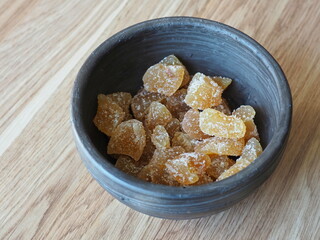 Oriental sweets in a container. Traditional crystallised ginger sweets. Ginger pieces with sugar