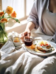 Obraz na płótnie Canvas Beautiful woman having breakfast in bed, home bedroom interior with bright morning light, healthy food on cozy decorated tray, weekend meal