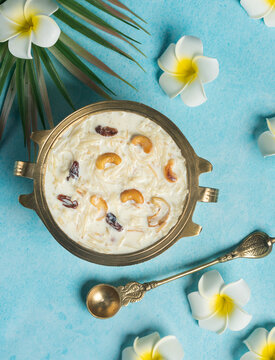 Top view of Payasam with flowers, Onam sweets dessert semiya payasam also known as Khir payasam in a golden vessel