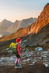 Obraz premium Child hiker with backpack in mountains active travel vacations outdoor family healthy lifestyle 4 years old kid exploring Norway