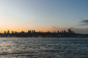 Fototapeta na wymiar View of bosphorus strait water at sunset with low light and skyline