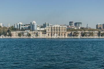 Fototapeta na wymiar View of bosphorus strait water at midday with blue waters and beautiful skyline with white palace