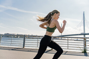Runner motivation and exercises for a healthy lifestyle. Athletic slim woman. A confident person...