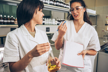 In a chemistry lab, two diligent workers conduct experiments, kindling their passion for science and discovery.