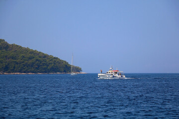 Small rustic boat on the promenade. Picturesque scene from Croatia.