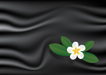 Tropical flower on wrinkles black fabric