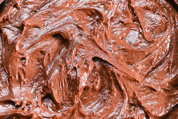 Texture of raw chocolate spread on the cake. Raw chocolate smeared on the cake. Shallow depth of field