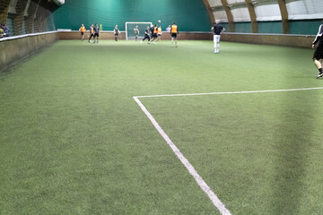 Futsal court and players playing during the match. Space for copy.