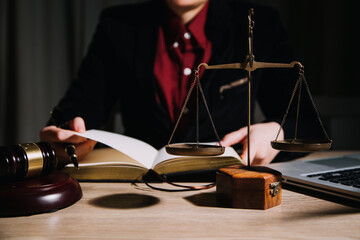 Justice and law concept.Male judge in a courtroom with the gavel, working with, computer and...