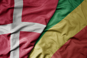 big waving national colorful flag of denmark and national flag of republic of the congo .