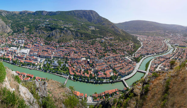 Amasya, Turkey - july 22, 2023 : Old Ottoman houses panoramic view by the Yesilirmak River in Amasya City. Amasya is populer tourist destination in Turkey. - Powered by Adobe