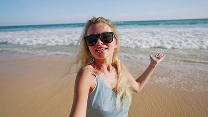 Women travels to tropical island and makes selfie video of herself about ocean view, nature and adventures. Female blogger records hot country landscapes and tells subscribers her emotions.