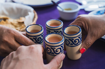 Cured guava mezcals served in a Talavera Puebla tequila caballito, typical Mexican drink