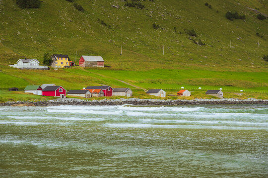 Turquoise Waves and Vibrant Norwegian Homes Near Maloy on a Cloudy Summer Morning