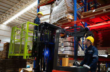 Warehouse workers using forklift to check and counting in a large warehouse. This is a large paper package storage and distribution warehouse. © Wosunan