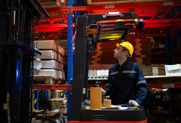 Warehouse workers using forklift to move products in a large warehouse. This is a large paper...