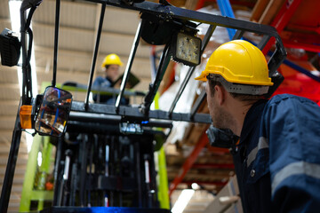 Warehouse workers using forklift to check and counting in a large warehouse. This is a large paper...