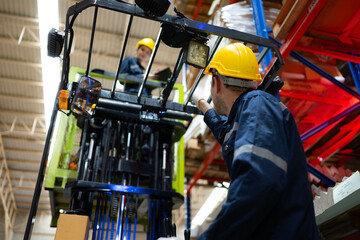 Warehouse workers using forklift to check and counting in a large warehouse. This is a large paper package storage and distribution warehouse. © Wosunan