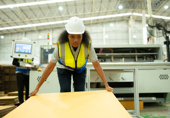 Young female checking a paper package in production line