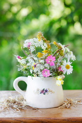 Fototapeta na wymiar Adorable bouquet of summer wild flowers.
