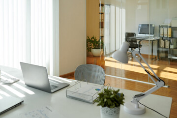 Laptop and reports on desk in modern office