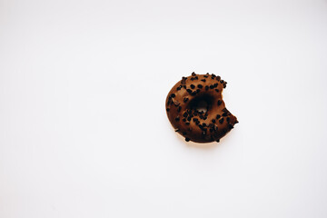 chocolate donut with sprinkles on white background 