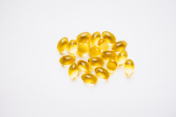 Fototapeta premium yellow capsules on a white background. medicines and vitamins