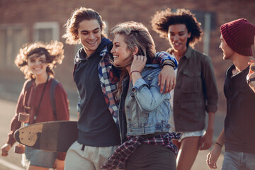 Young and diverse group of friends walking and having fun in the city