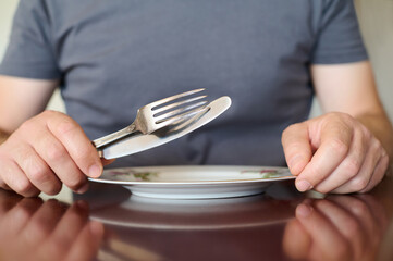 Obraz na płótnie Canvas Empty Plate with Fork and Knife: Ready for a Meal