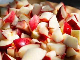 Chopped apples. Pieces of apple. Red sliced pie apple. Selective focus