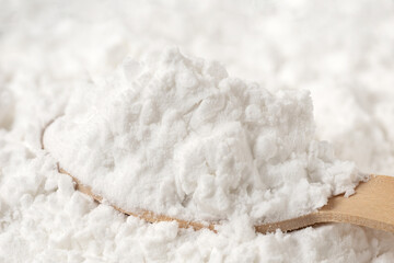 Background of potato starch with a spoonful of potato starch.