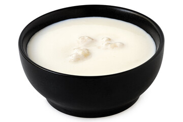 Milk with kefir grains in a black ceramic bowl isolated on white. - 646506621