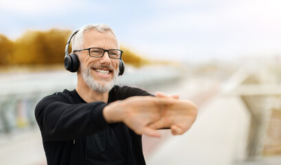 Cheerful retired sportsman warming up before workout outdoor