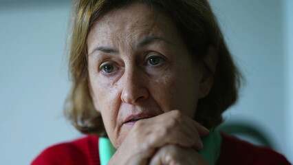 Close-up of senior woman, immersed in conversation, signaling affirmation with a nod while...