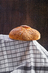 Loaf of artisanal bread in a Tea Towel