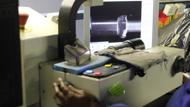 diamond polishing factory, african woman working and watching closely the quality on the monitor