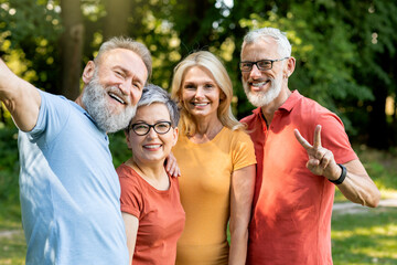 Portrait Of Cheerful Men And Women Taking Selfie Together Outdoors