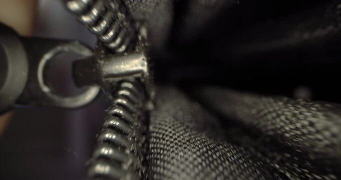 Close-up of a man's hand closing a jacket with a zipper. Close-up video of clothes being closed with a lock. High quality 4k footage