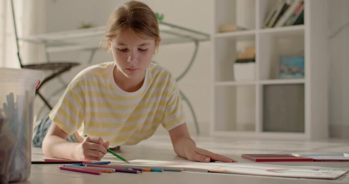 Symphony of Colors: Exploring the Artistic Odyssey of a Teenage Girl through Colorful Pencil Creations at Home. High quality 4k footage