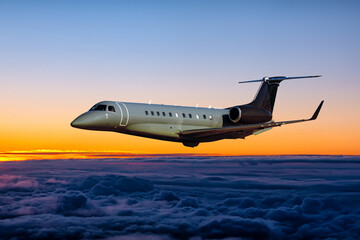 Modern luxury business jet fly in the sunrise sky