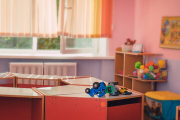 Kindergarten interior with game room and plastic toys on wooden table for children education