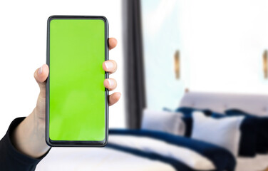 hand showing a smart phone screen in hotel room