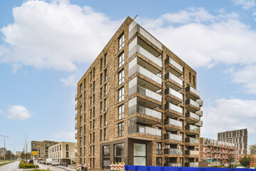 Apartment building with modern glass balconies in city