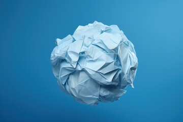 Obraz premium Crumpled paper ball isolated, blue background. Generative AI