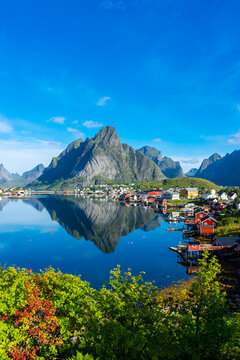 Perfect reflection of the Reine village on the water of the fjord in the Lofoten Islands,  Norway