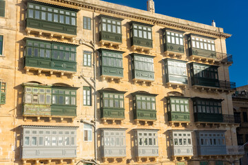 Fototapeta na wymiar Traditional colorful maltese balconies (Gallarija) on a building in Valletta old town, Malta