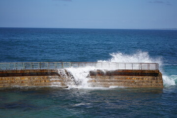 Waves breaking over a wall in San Diego