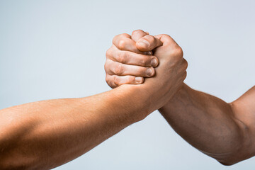 Friendly handshake, friends greeting, teamwork, friendship. Rescue, helping gesture or hands. Two hands, helping arm of a friend, teamwork. Helping hand outstretched, isolated arm, salvation