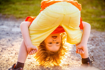 Child playing. Freedom of self expression and behaviour for kids. Happy cute child standing upside...